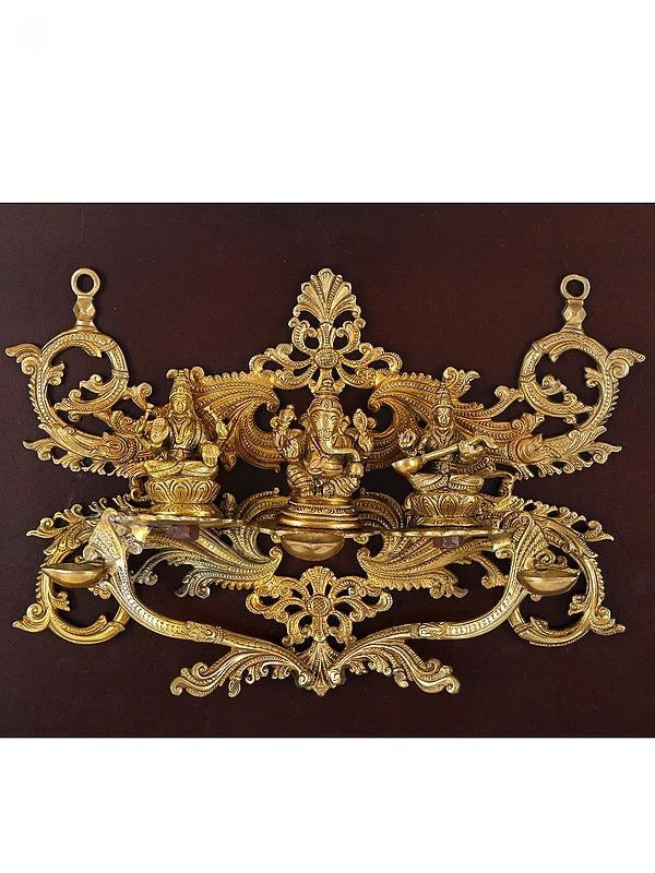 Brass Lakshmi, Ganesha, and Saraswati in Wooden Frame Wall Hanging (Height: 24 Inch)
