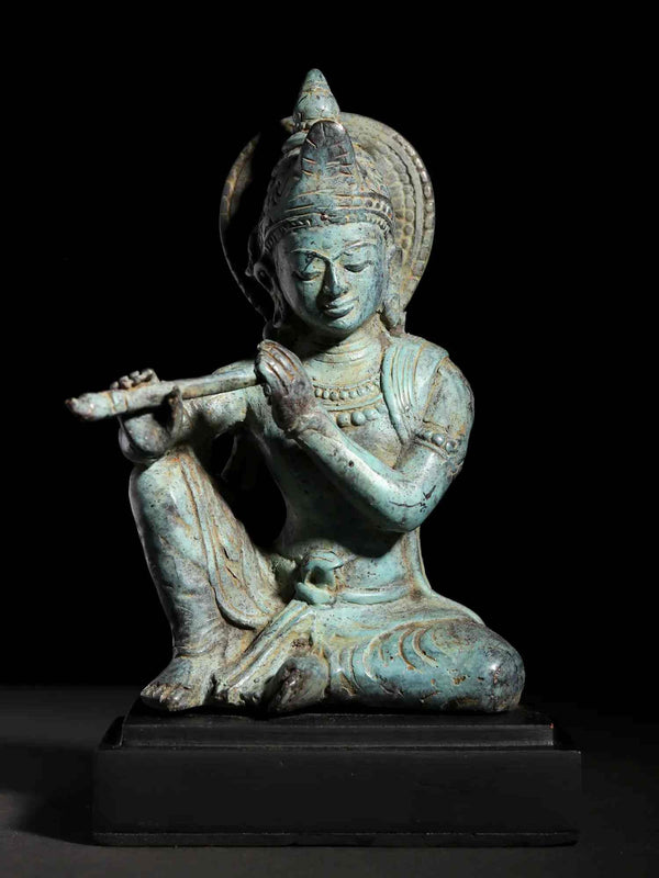 Small Brass Idol of Murli Manohar Krishna Seated on a Wooden Base 6 Inches Entryway Setting
