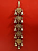 AONA Brass Wall Hanging featuring Lakshmi, Ganesha, and Saraswati with bells