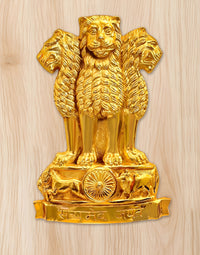 Golden metal lion wall hanging with Ashoka chakra emblem on the base