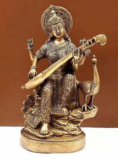 Brass Saraswati statue holding veena, seated with raised hands, ornate details