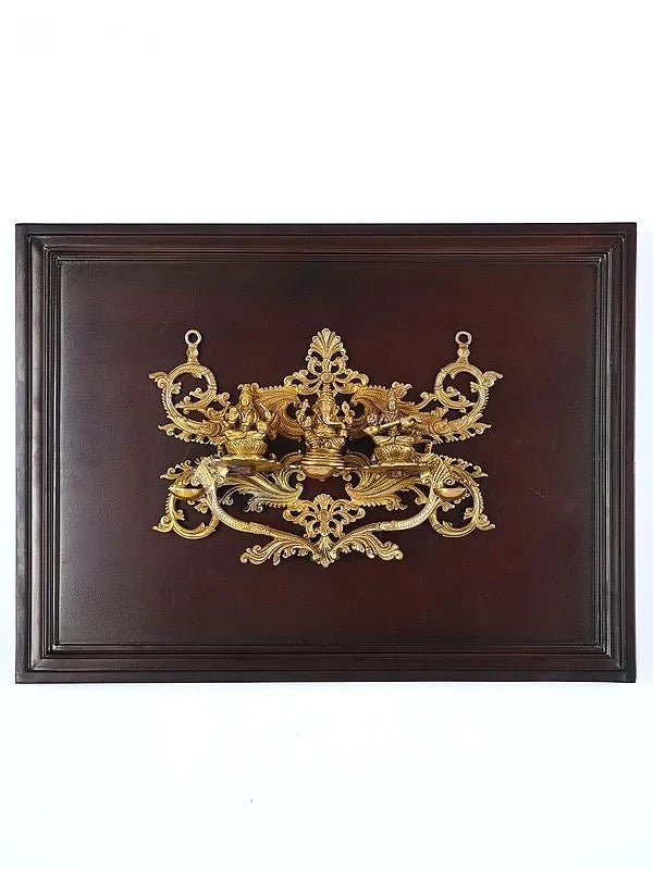 Brass Lakshmi, Ganesha, Saraswati wall hanging in wooden frame, ornate centerpiece