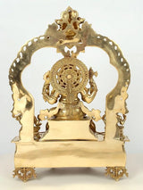 Brass Ganapati back view with circular halo and crest, standing attendants on throne
