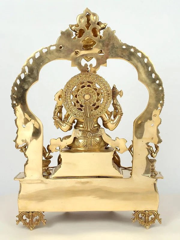 Brass Lord Ganapati Seated on Kirtimukha Throne with Lakshmi and Saraswati (Height:22 Inches) Study Setting