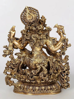 Saraswati brass sculpture, four-armed pose holding veena, richly carved base