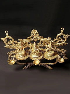Brass dipam wall hanging with Lakshmi and two seated deity lamp holders