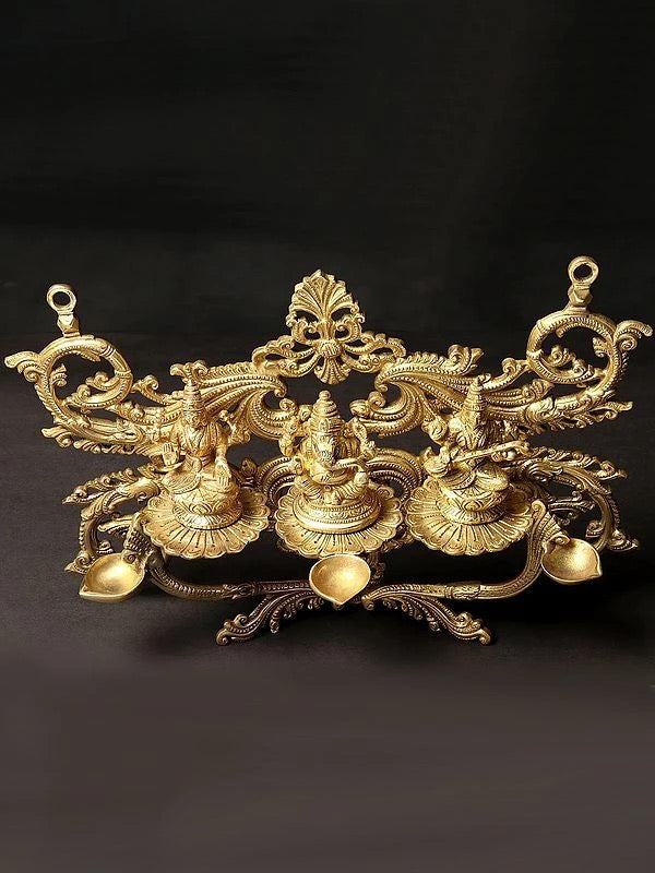 Brass Lakshmi, Ganesha, and Saraswati Wall Hanging with Dipam (Height: 14 Inch)