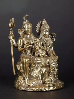 Brass Shiva-Parvati-Ganesha family idol, side view; trident upright, ornate halos