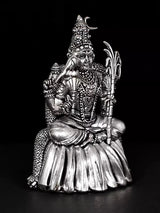 Rajarajeshwari statue, silver-tone finish, holding trident-like staff while seated