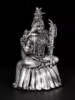 Rajarajeshwari statue, silver-tone finish, holding trident-like staff while seated