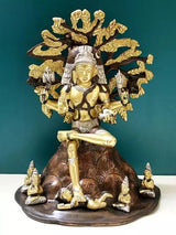 Brass Dakshinamurti Shiva statue, seated figure with ornate halo and attendants, 12 inch