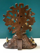 Brass Dakshinamurti Shiva statue, rear view of large disk backdrop and seated legs