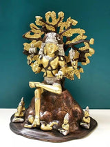 Brass Dakshinamurti Shiva statue, front view with tall headdress, seated on lotus base