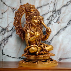 Brass Hanuman ji sitting idol, side view, raised arm and gada, ornate back halo.