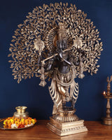 Brass Lord Krishna statue on ornate pedestal, kalpavriksha canopy with detailed leaves