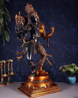 Ardhanarishvara brass statue in black and gold, arms raised, on ornate round base