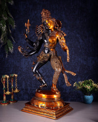 Ardhanarishvara metal statue, side view with trident and patterned ornaments, golden torso