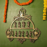 Brass Dashavatar wall decor with halo top, filigree border, and ten engraved standing avatars