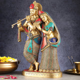 Standing Radha Krishna brass statue, Radha’s arm around Krishna, ornate patterned robes