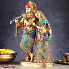 Standing Radha Krishna brass statue, Radha’s arm around Krishna, ornate patterned robes