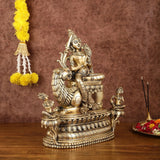 Brass Tara Devi seated on lion base with winged detail and attendants, 16 in