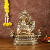 Brass Tara Devi statue on lion pedestal with raised hand and carvings, 16 in