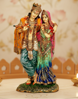 Radha-Krishna idol statue, Krishna holding a red flute with Radha in green sari