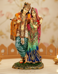 Radha-Krishna idol statue, Krishna holding a red flute with Radha in green sari