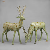 Standing brass deer sculpture with leaf-green patina and gold speckles, front view
