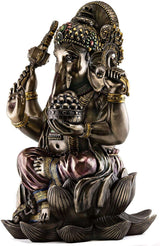 Gold-tone Ganesha resin statue with jeweled headpiece, trunk, raised hands, seated on lotus