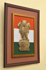 Brass Ashoka stambh emblem in wooden wall frame on tricolour background