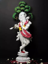 Krishna idol statue with gold bansuri, white figure, flower garlands in pink/yellow