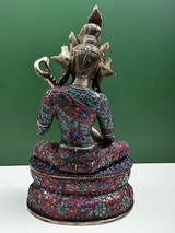 Saraswati idol from behind, seated brass figure with veena, ornate inlay patterns