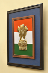 Wood-trim wall frame showing a brass Ashoka pillar emblem over tricolour background