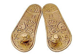 Gold brass charan paduka soles with engraved patterns and central emblem, pair