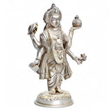 Silver Dhanvantari brass statue standing with raised hands and ornate headdress