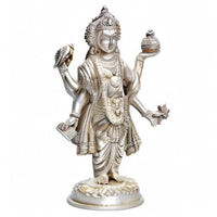 Silver Dhanvantari brass statue standing with raised hands and ornate headdress