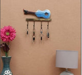 Blue iron guitar key hook wall rack with five hanging keys on bar mount