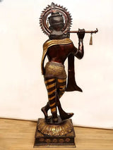 Brass Murli Krishna idol from back view, raised flute posture, gold trim and scarf