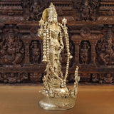Brass Vishnu idol, standing profile with raised arms and detailed armor ornaments