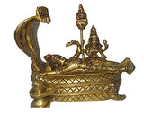Golden brass idol reclining, cobra hood behind and detailed jewelry on serpent bed