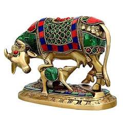 Brass cow and calf idol, angled view, red and blue accents on decorated body
