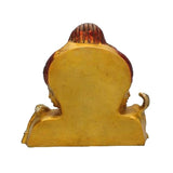 Back view of brass Shiva three-faced statue in yellow finish, textured carved surface