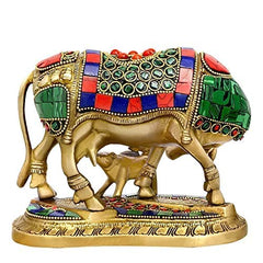 Brass cow and calf deity idol, side view, decorated saddle with green circle patterns