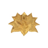 Brass lotus wall decor detail, close-up of textured backplate
