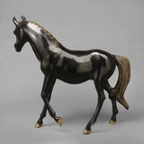 Horse statue side view; glossy dark bronze with gold-toned mane and hoof tips