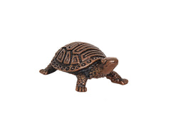 Copper tortoise figurine, side view with patterned shell and raised legs