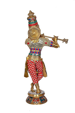 Krishna brass idol with flute in left hand, patterned red trousers and gold disc back