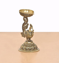 Brass peacock diya holder statue, detailed feathers, swirling support, round base