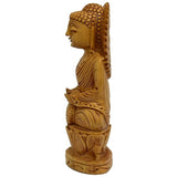 Carved wooden Buddha statue, side profile with detailed hair and robe folds